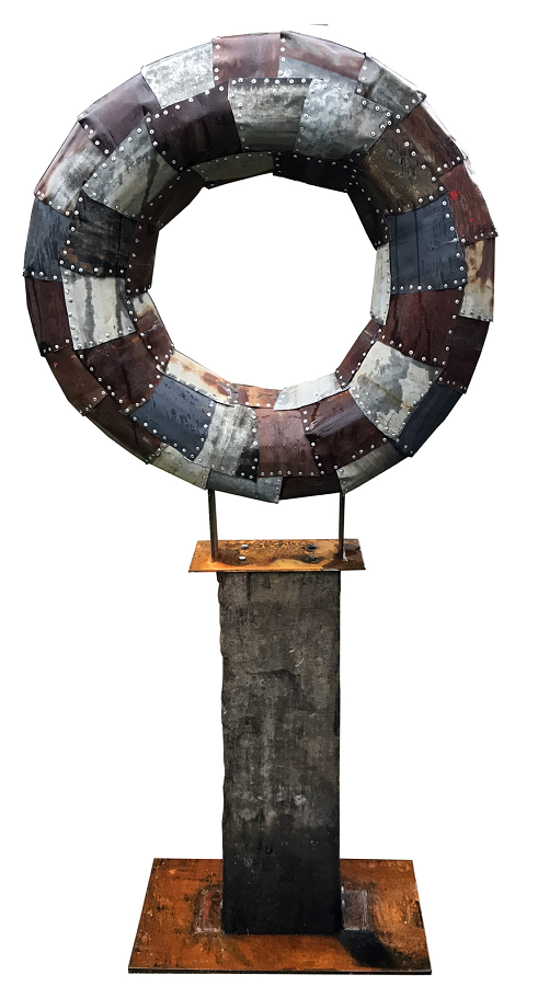 Hollow-round recycled metal sculpture on timber sleeper